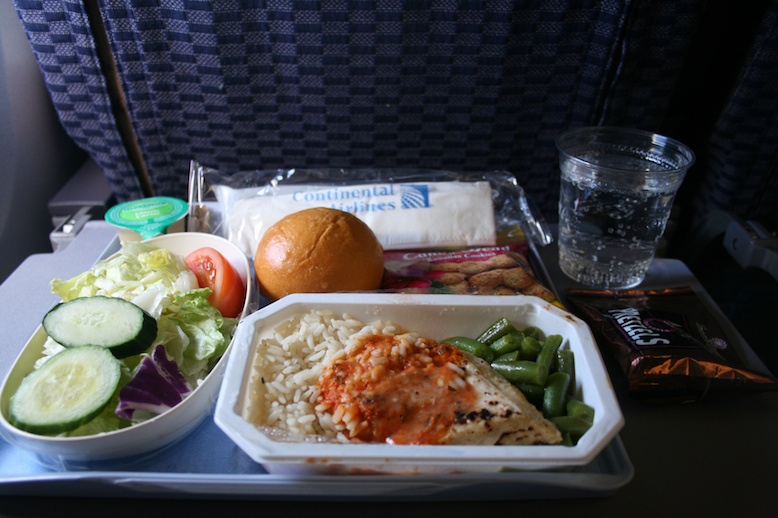 a meal on a tray with a sandwich and salad