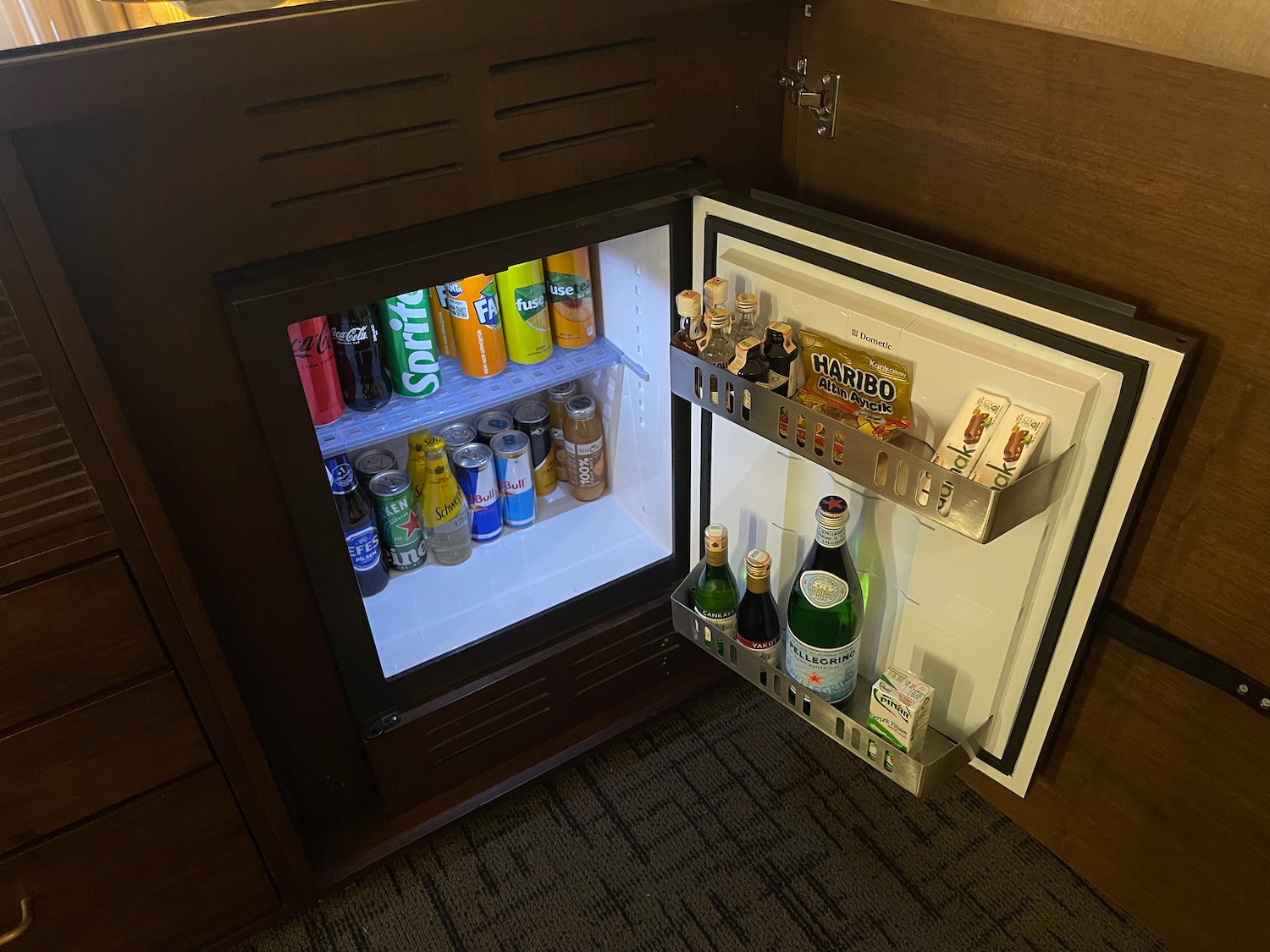 a mini fridge with drinks and beverages inside
