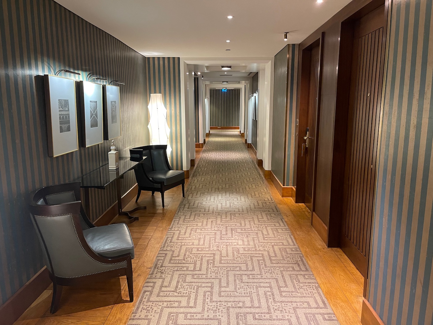 a hallway with chairs and a table