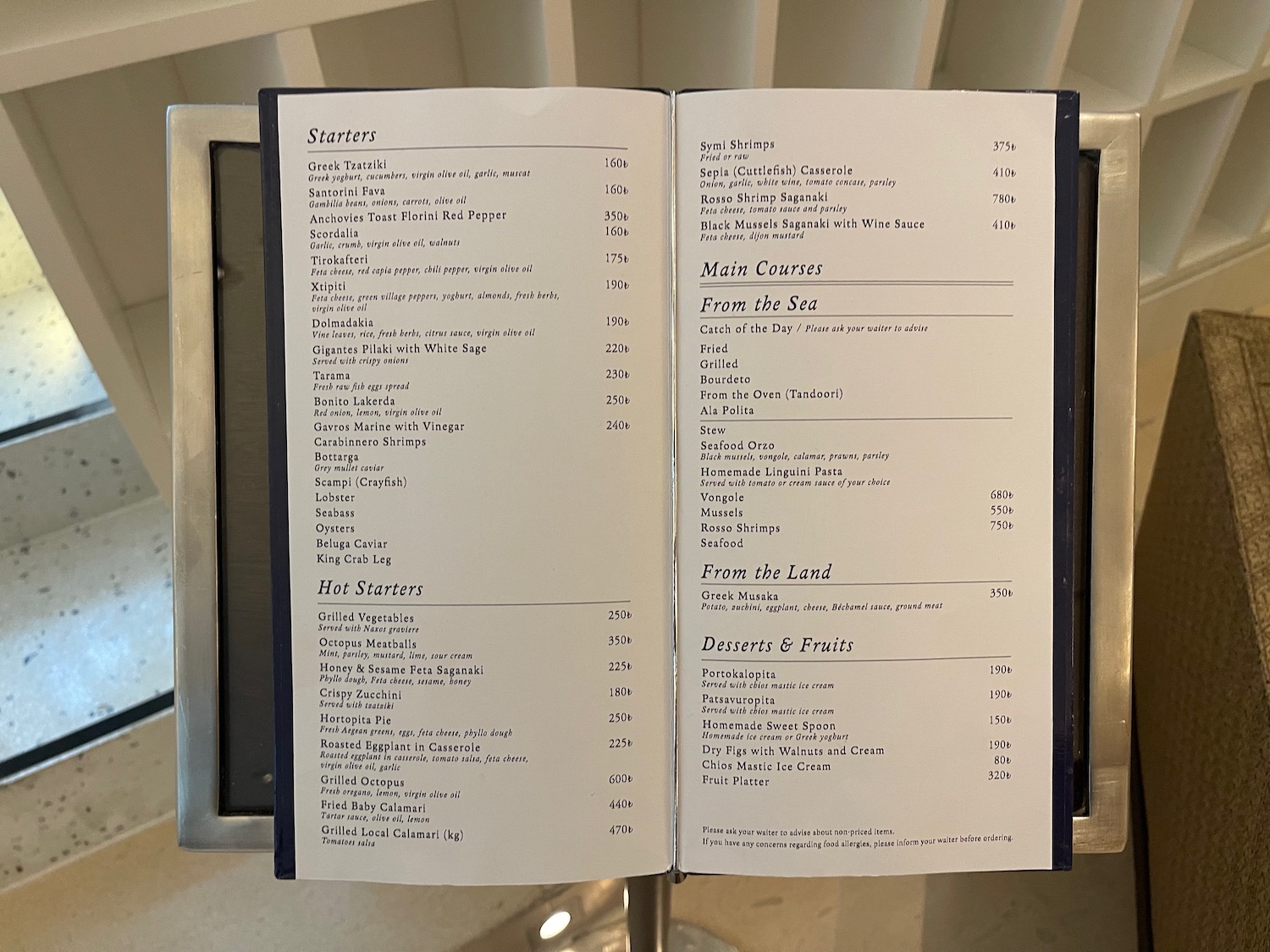 a menu open on a metal stand