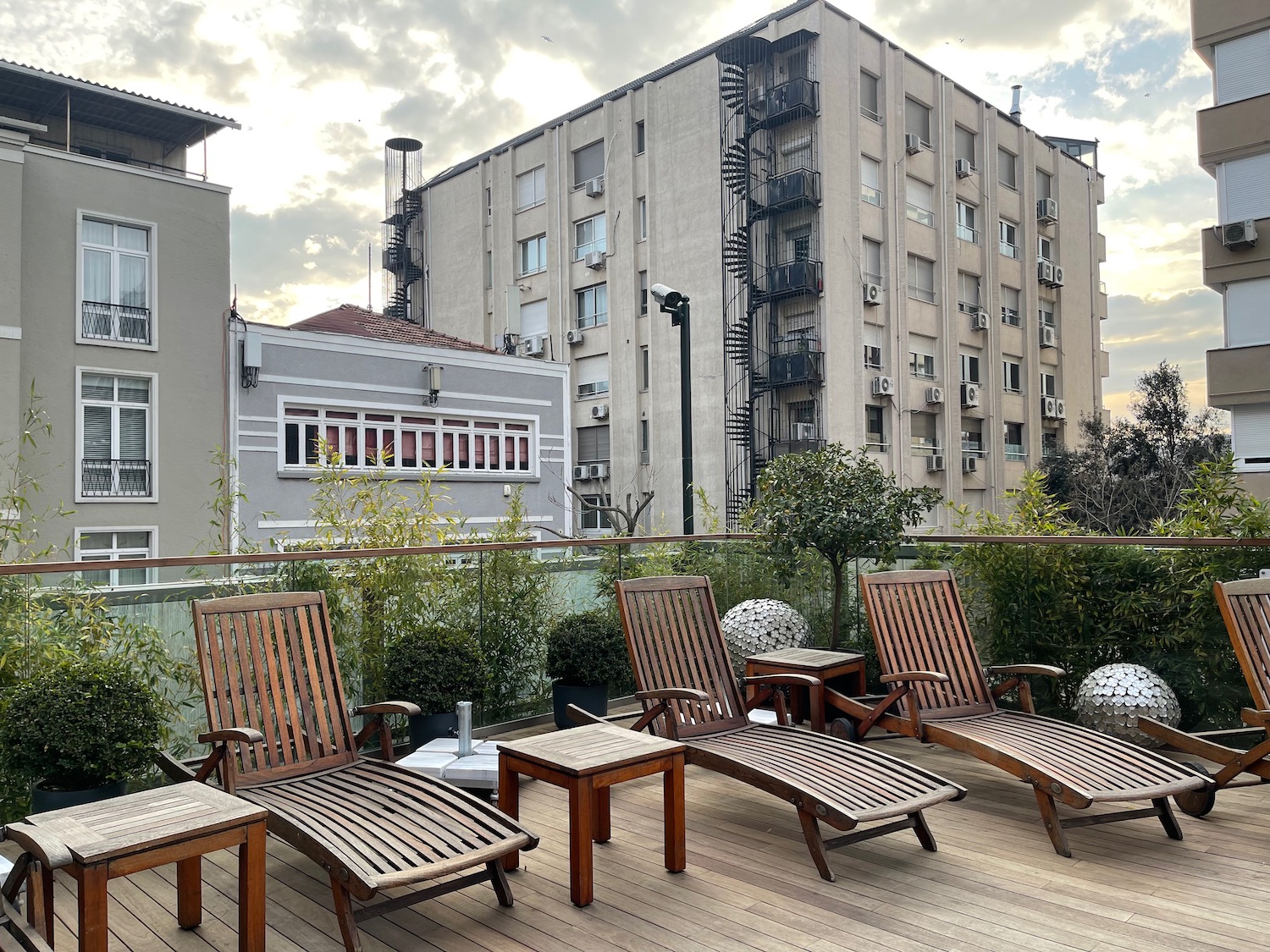 a deck with chairs and tables on a rooftop