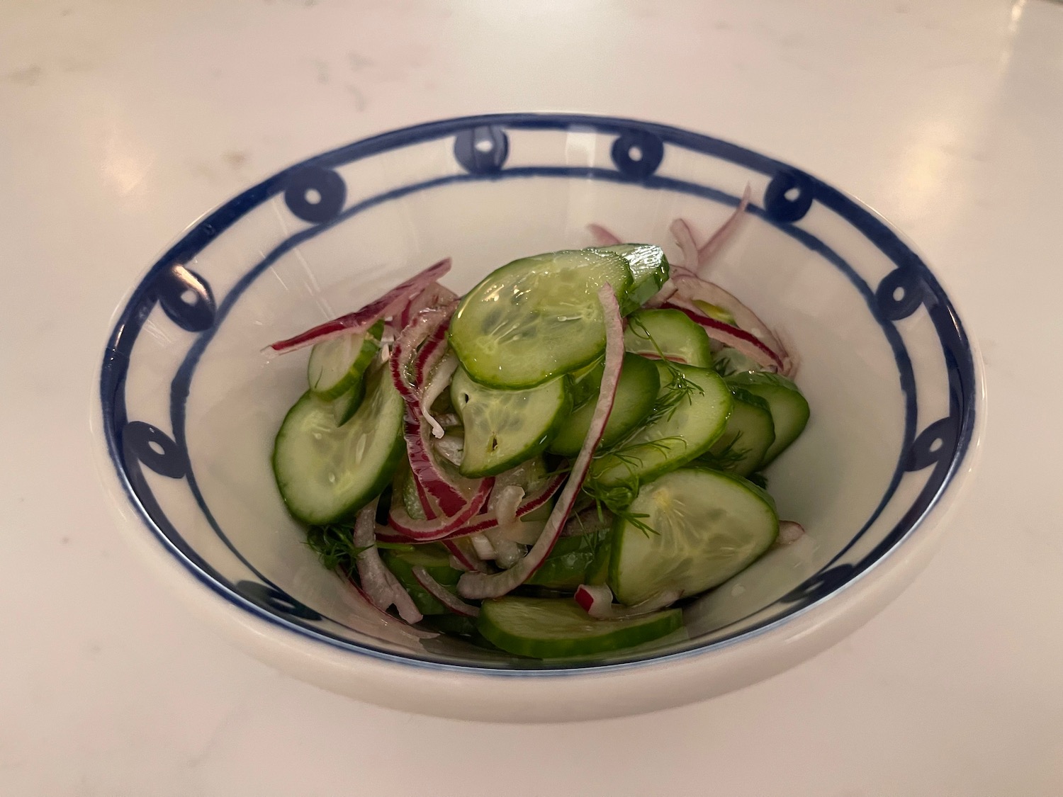 a bowl of cucumber and onions