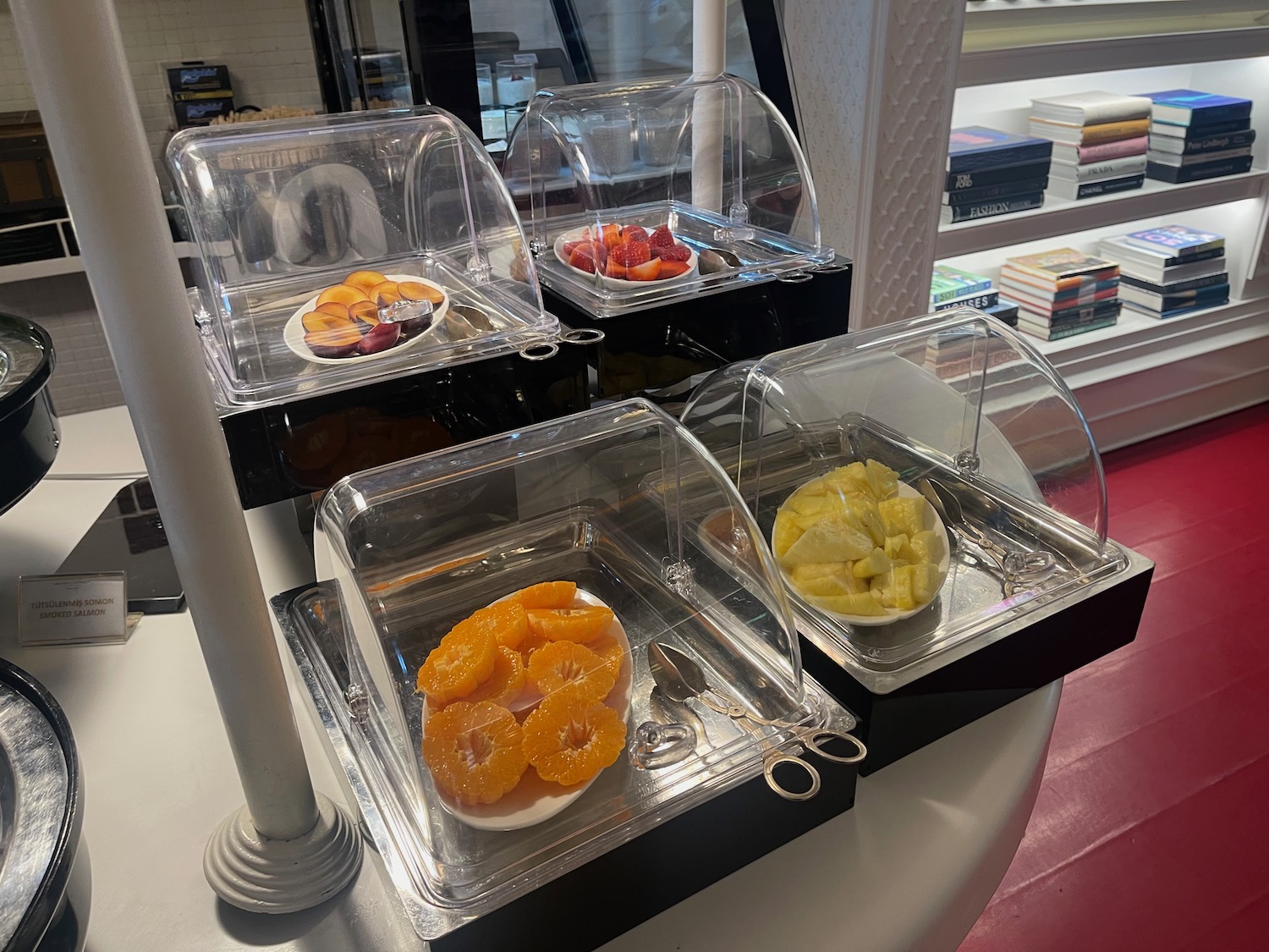 a group of trays of fruit in a display case