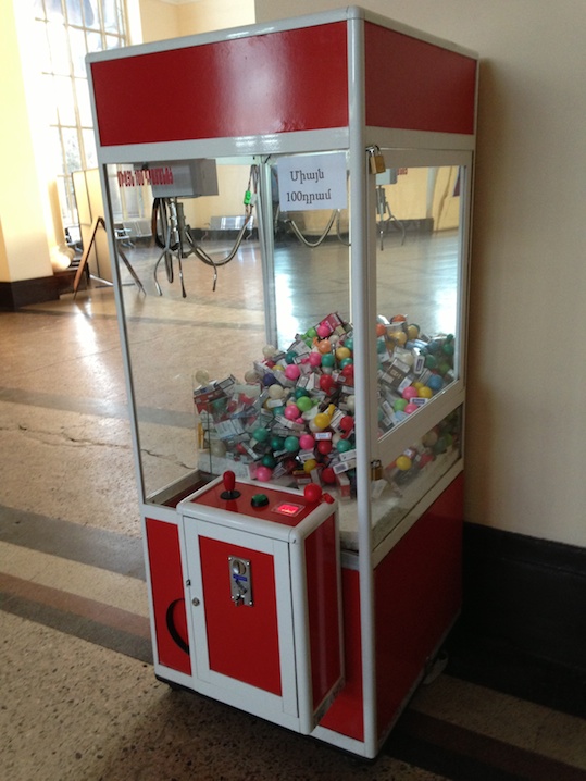 a red and white machine with a bunch of colorful balls inside