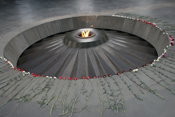 a circular fire pit with flowers around it