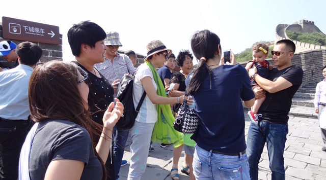 a group of people standing on a sidewalk