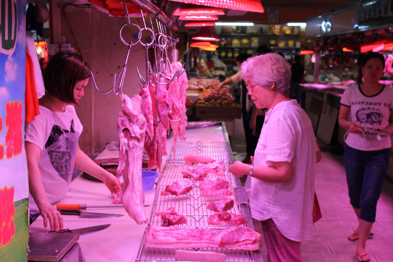 a woman standing in a butchery