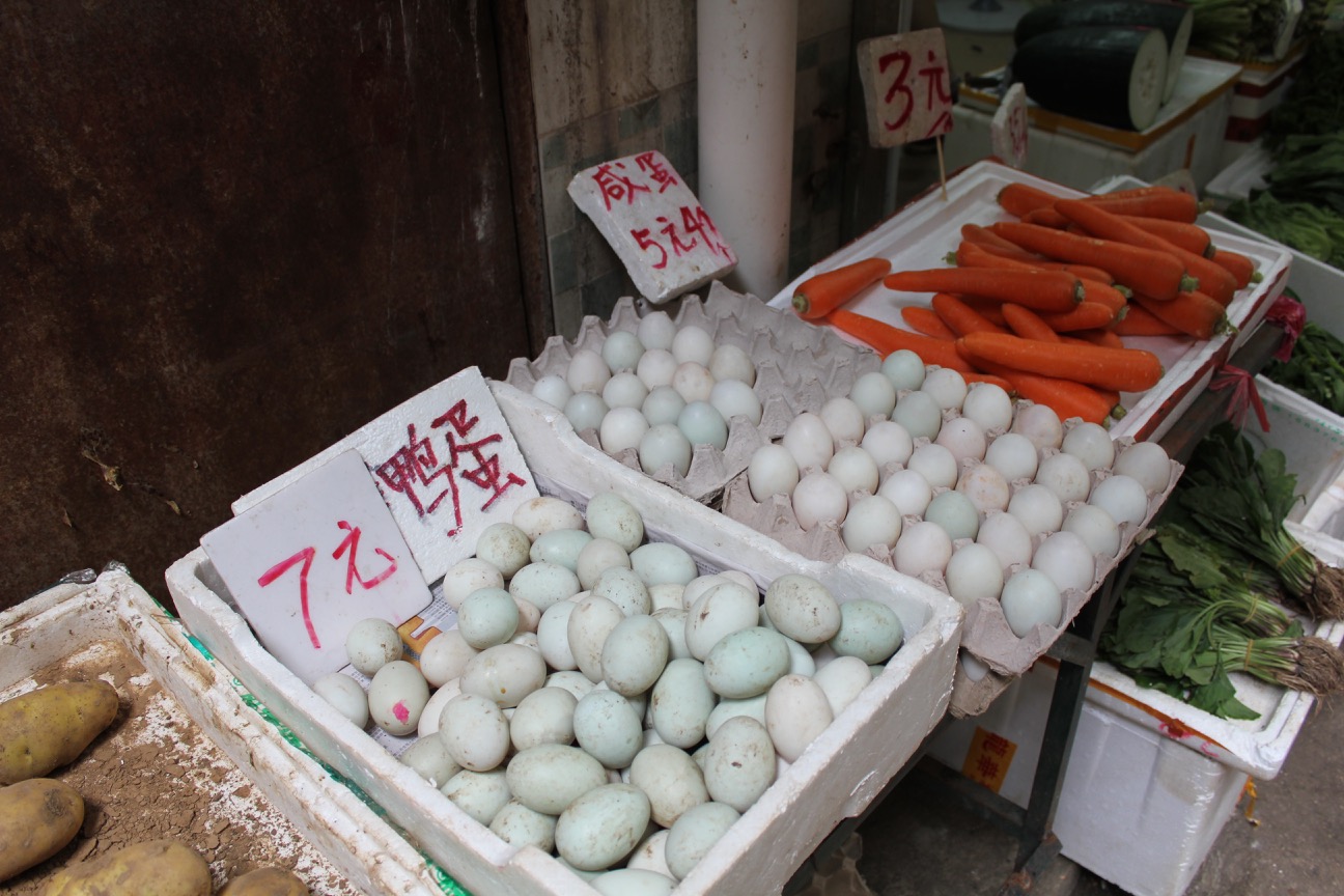 eggs and carrots in cartons on a table