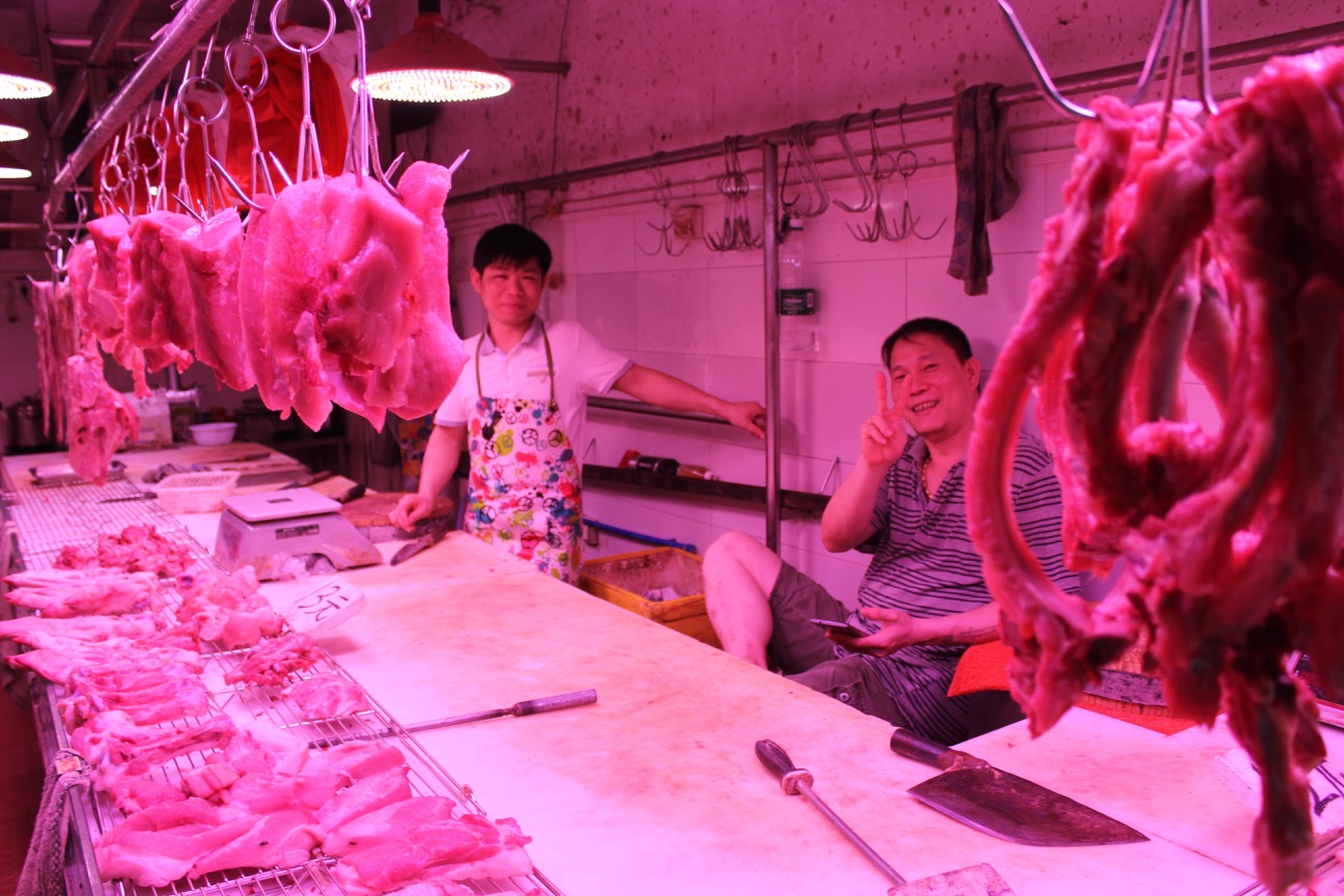 a group of men in a butchery