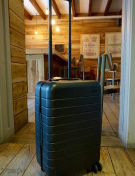 a black suitcase with long handle