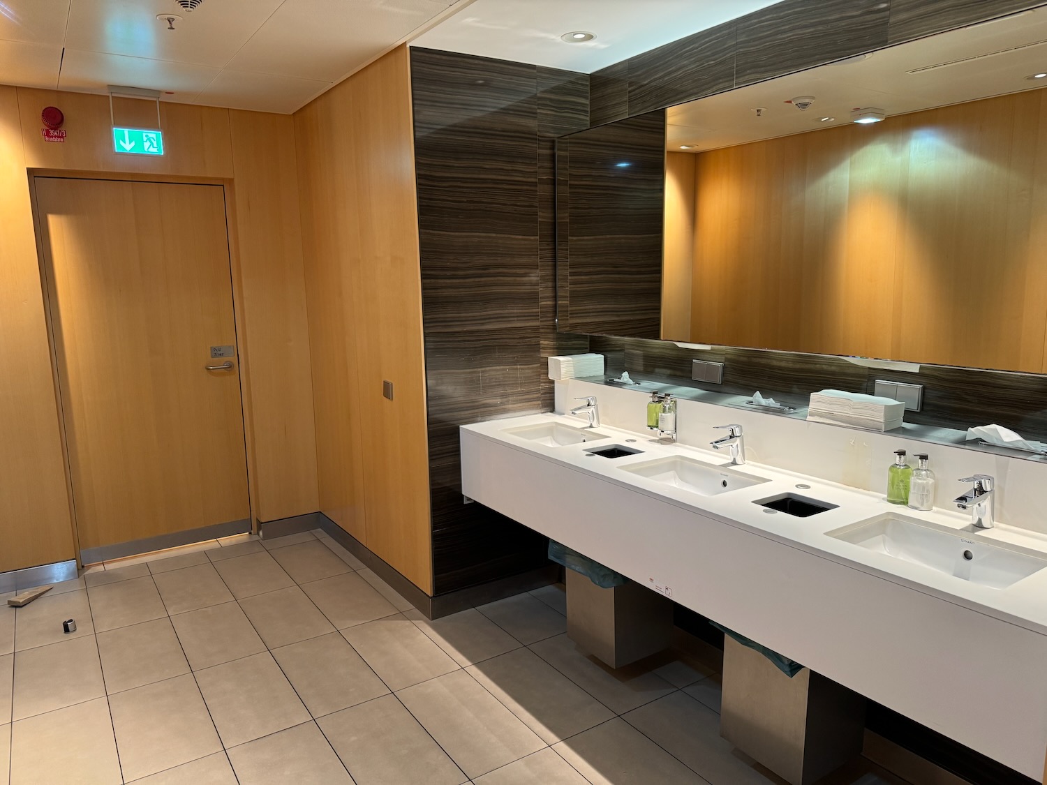 a bathroom with sinks and a door