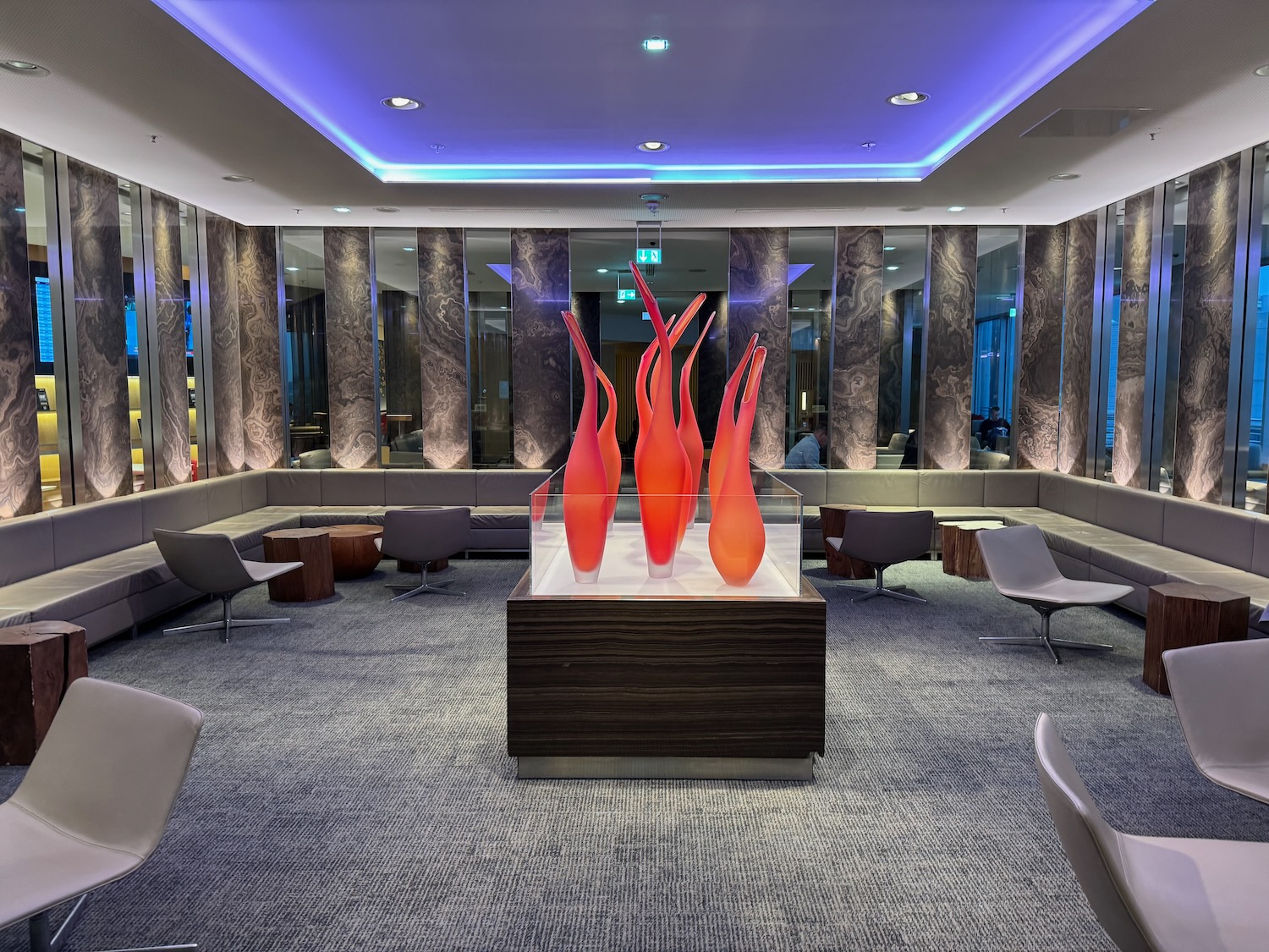 a room with a glass display with red glass objects