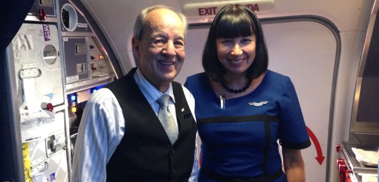 a man and woman standing in a plane