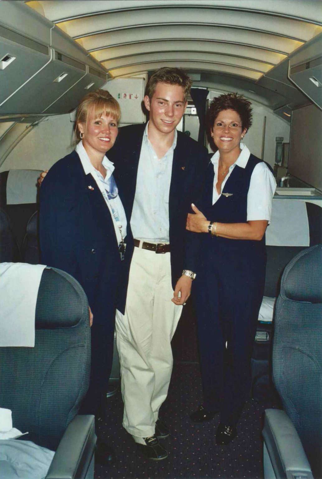 a group of people standing in an airplane