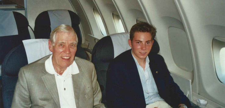 two men sitting in an airplane