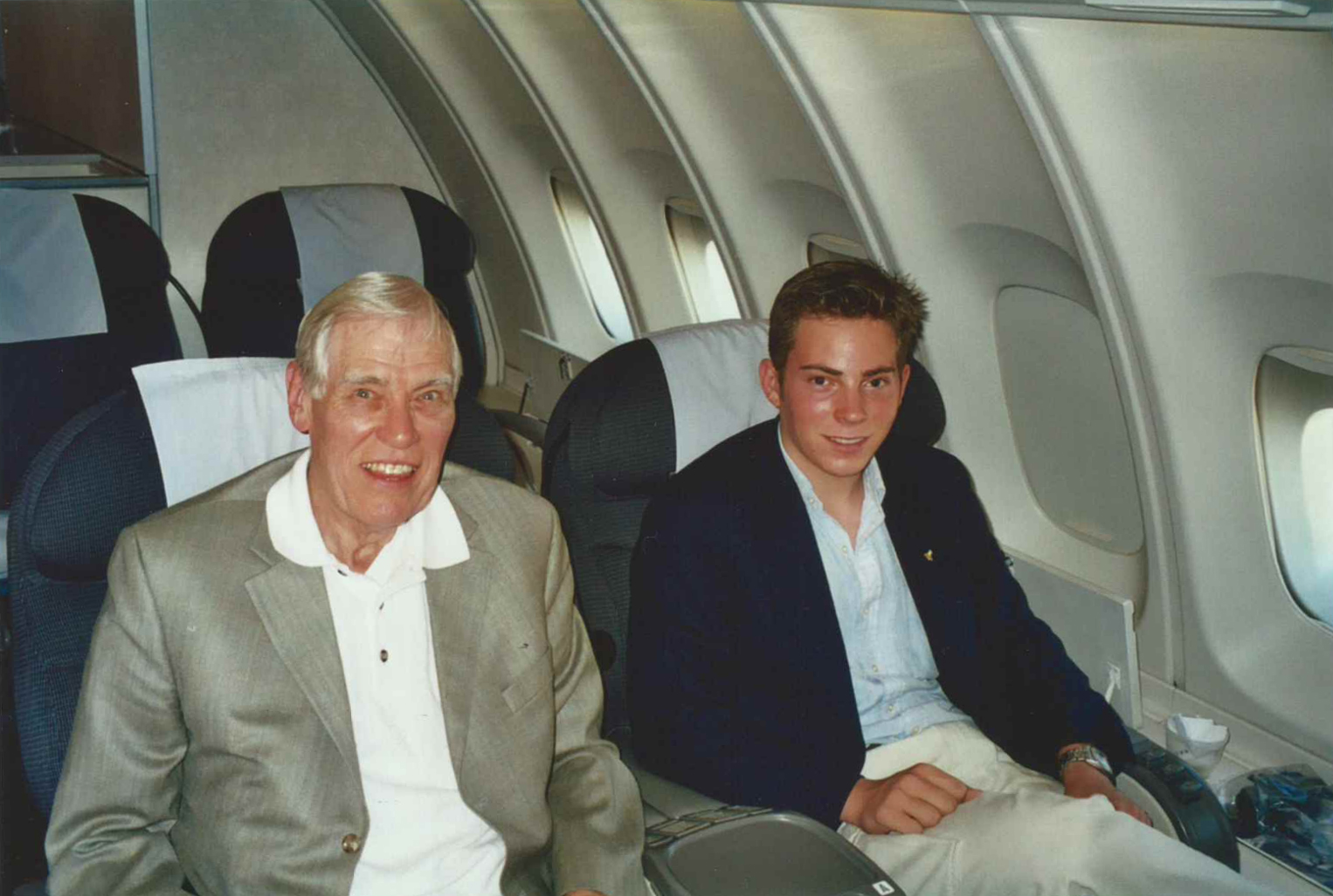 two men sitting in an airplane