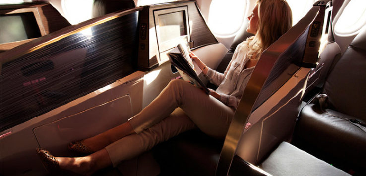 a woman reading a magazine on a plane