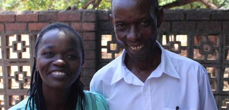 a man and woman smiling for a picture