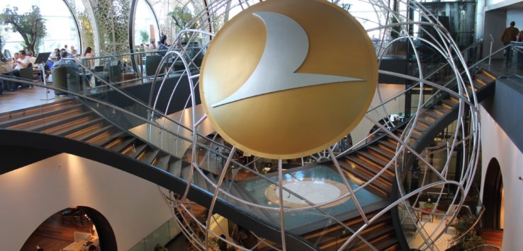 a circular sign with a gold circle in the middle of a building