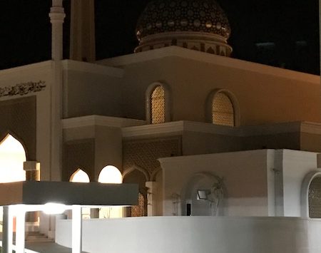 a building with a dome and a white wall