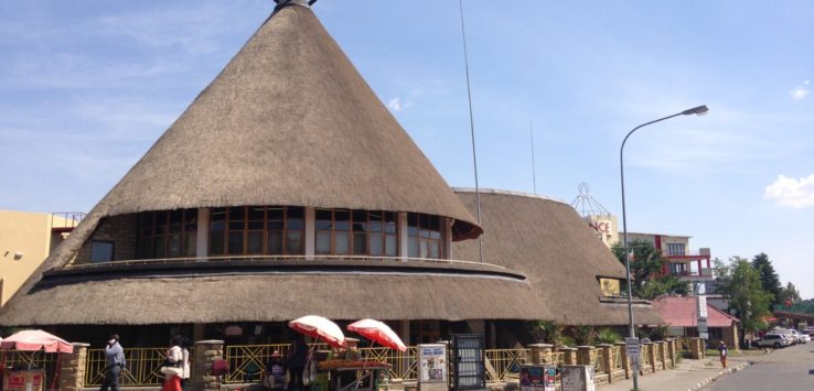 a building with a round roof and a large cone shaped roof