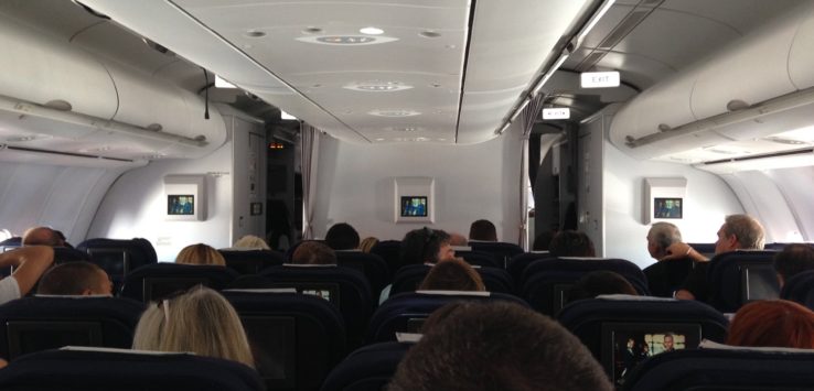 a group of people sitting in an airplane