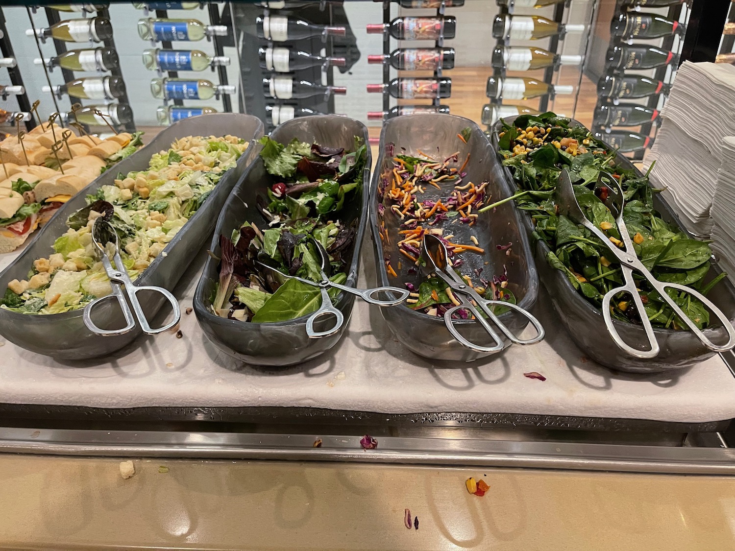 a row of bowls of salads