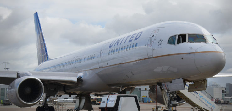 a large white airplane with blue and white text on it