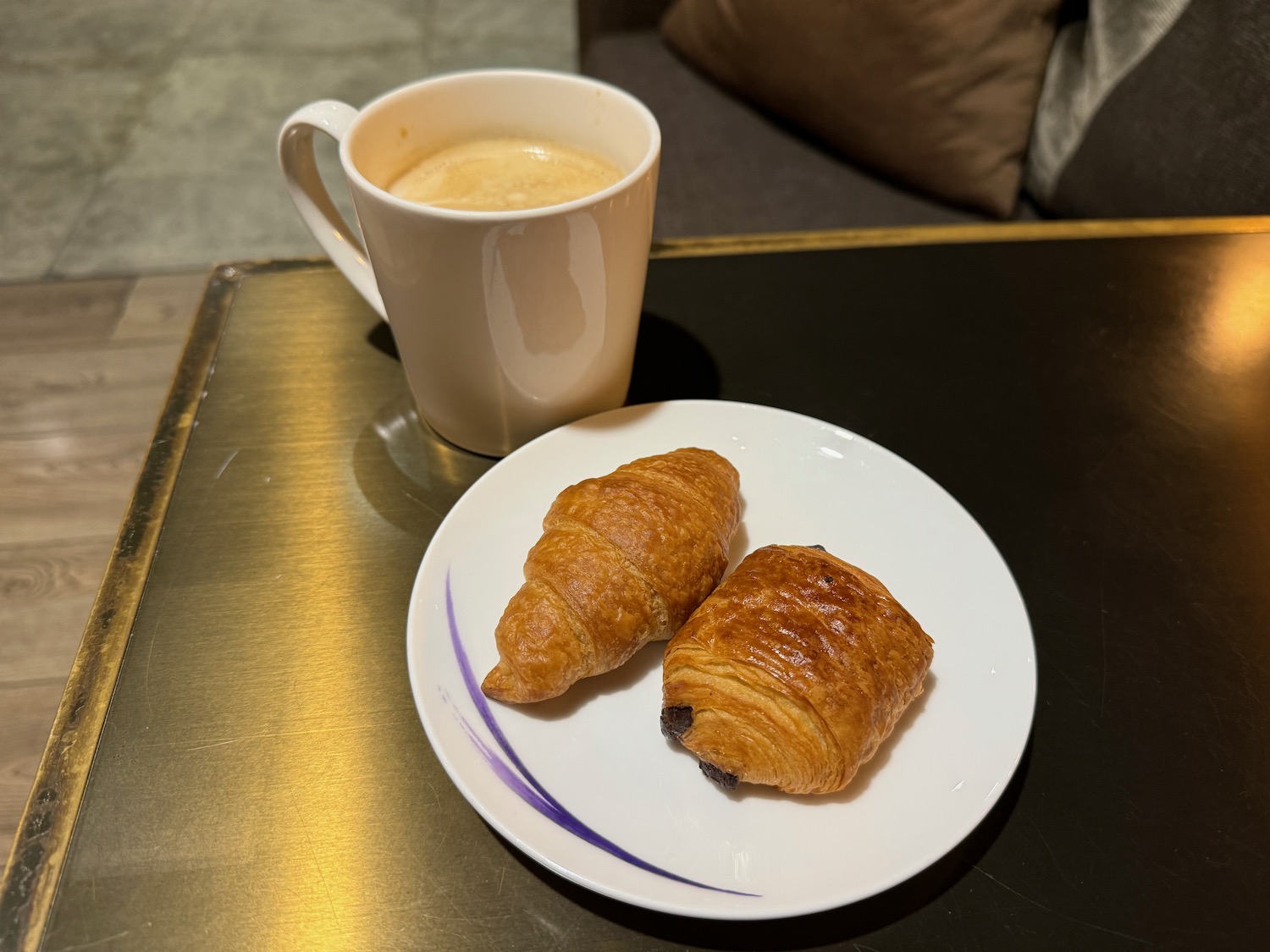 a plate of croissants and a cup of coffee