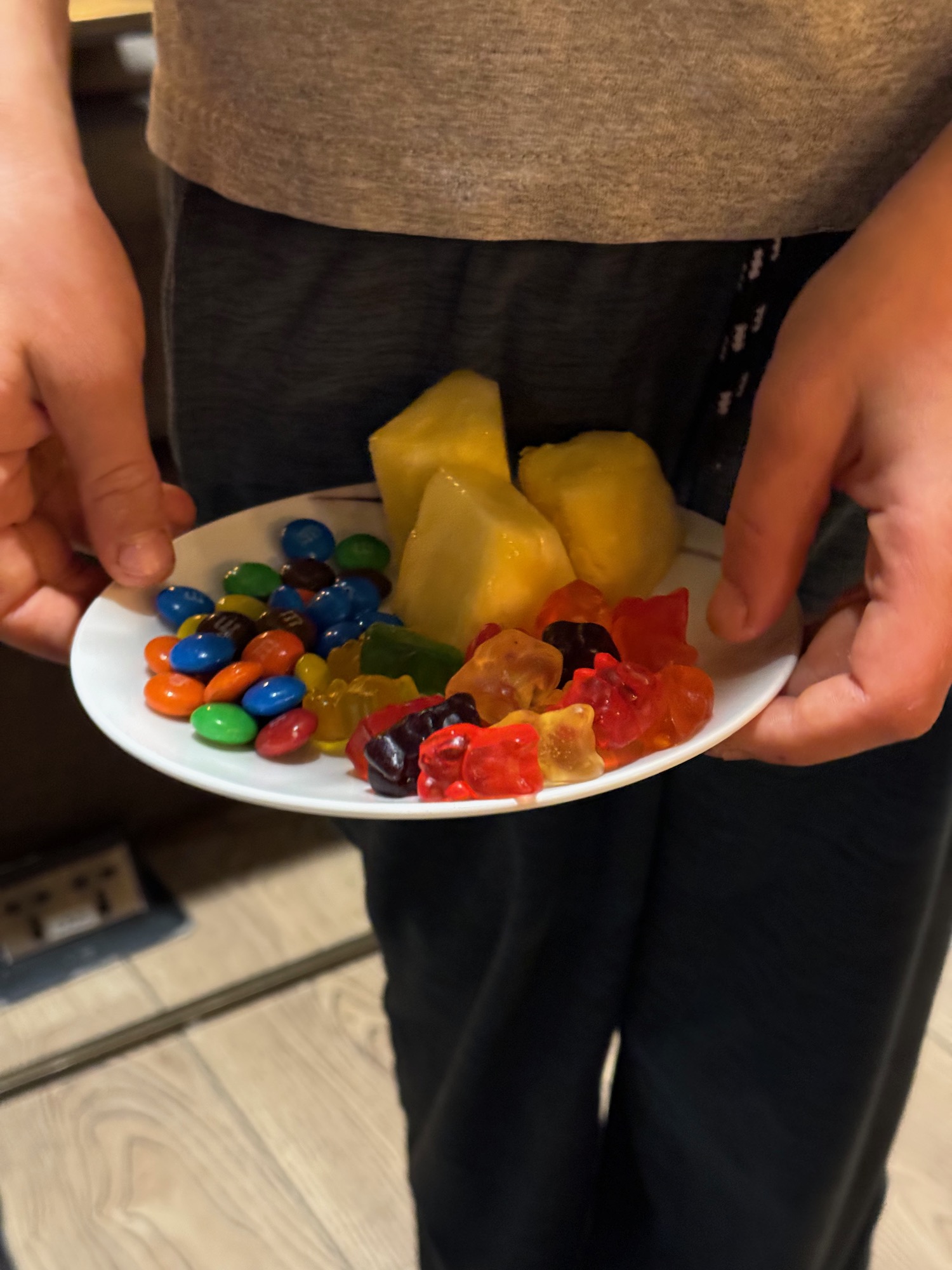 a plate of candy and fruit