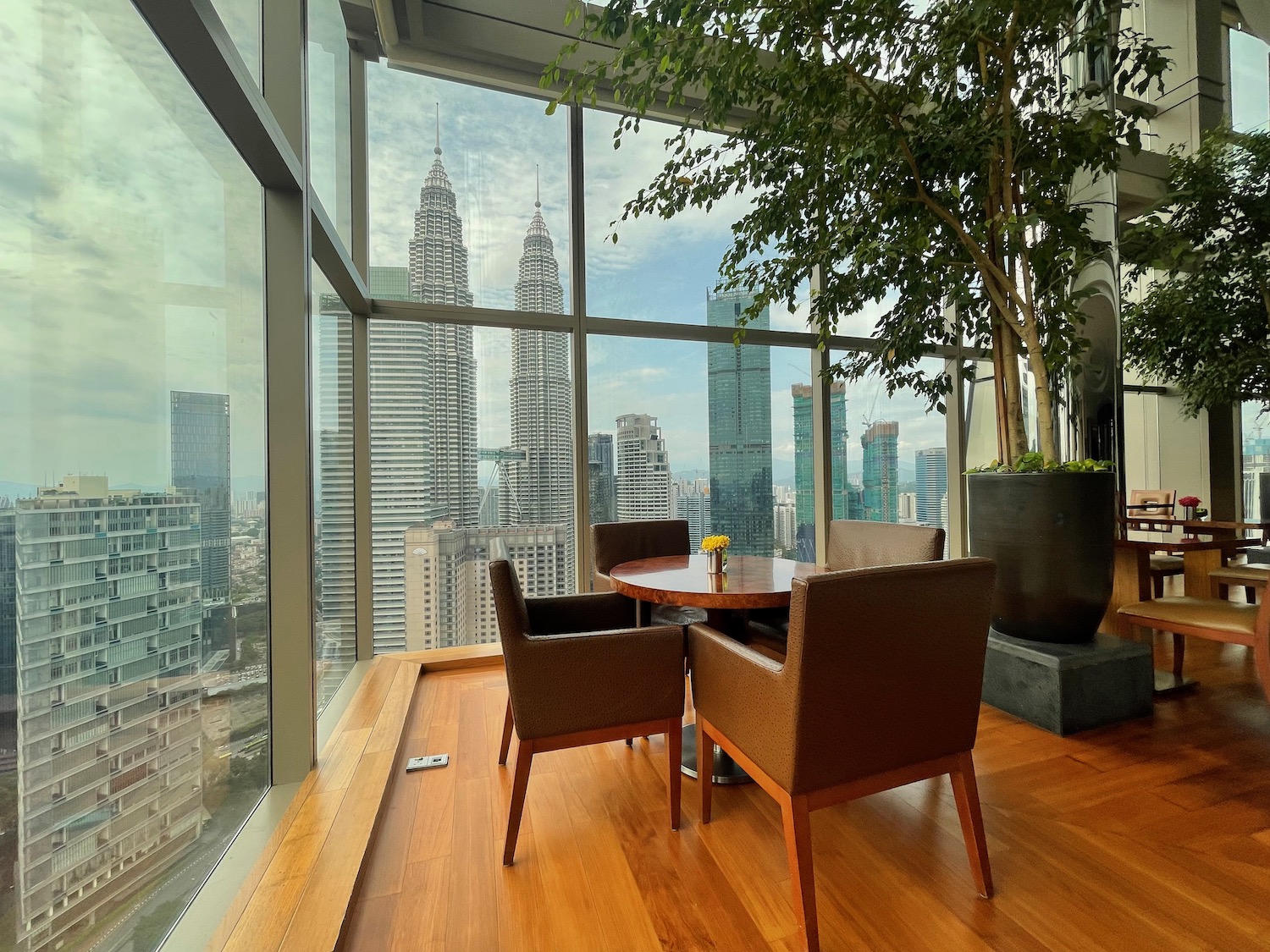 a table and chairs in a room with a view of a city