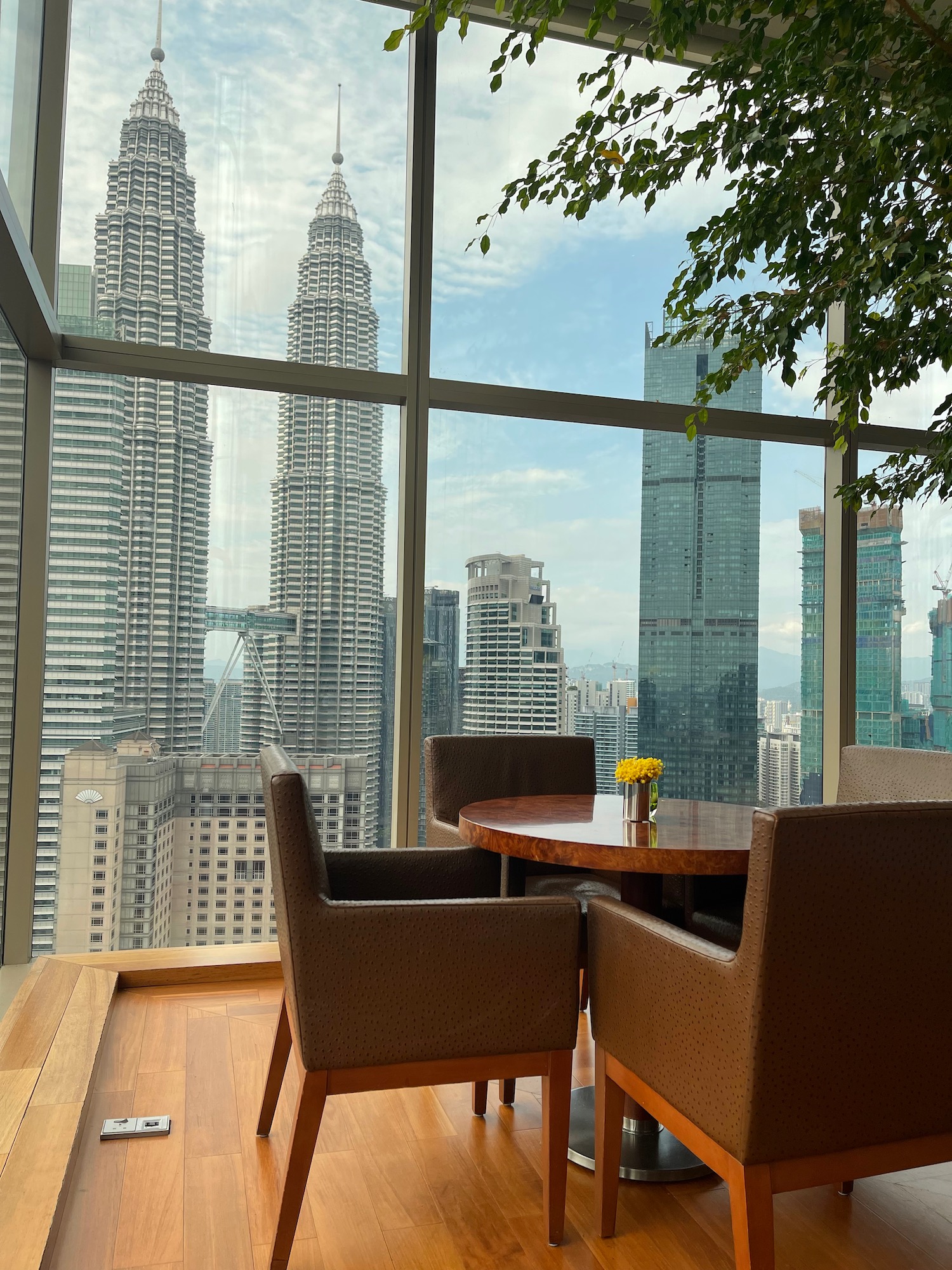 a table and chairs in a room with a view of a city