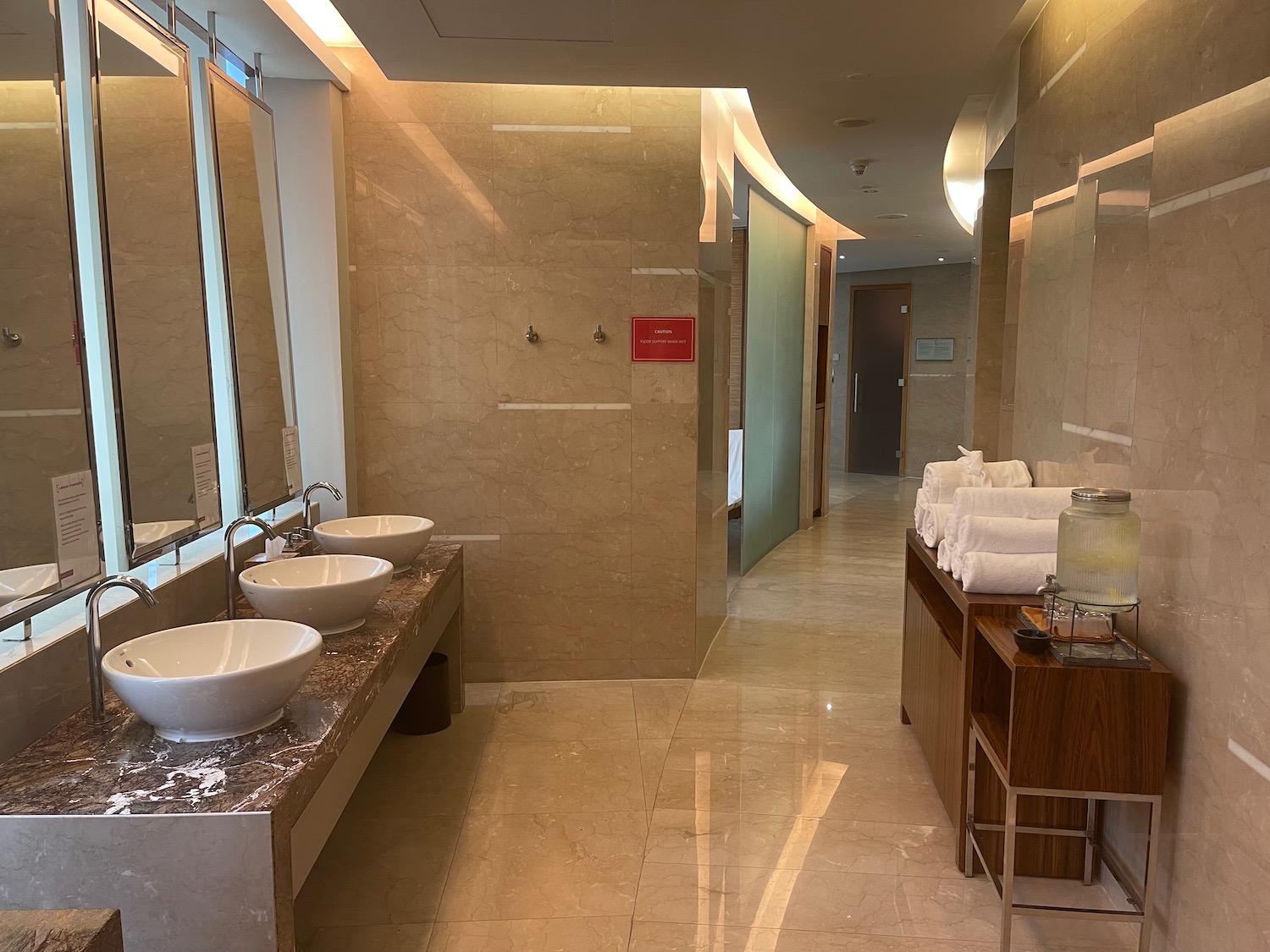 a bathroom with sinks and towels