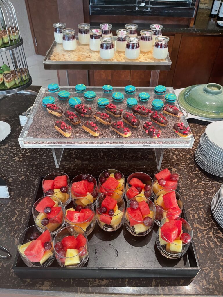 a tray of fruit and desserts