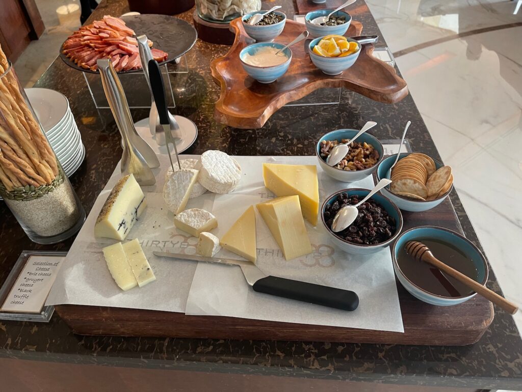 a table with different types of cheese and other food items