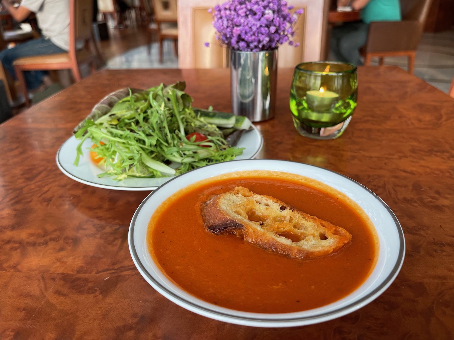 a bowl of soup and a salad on a table