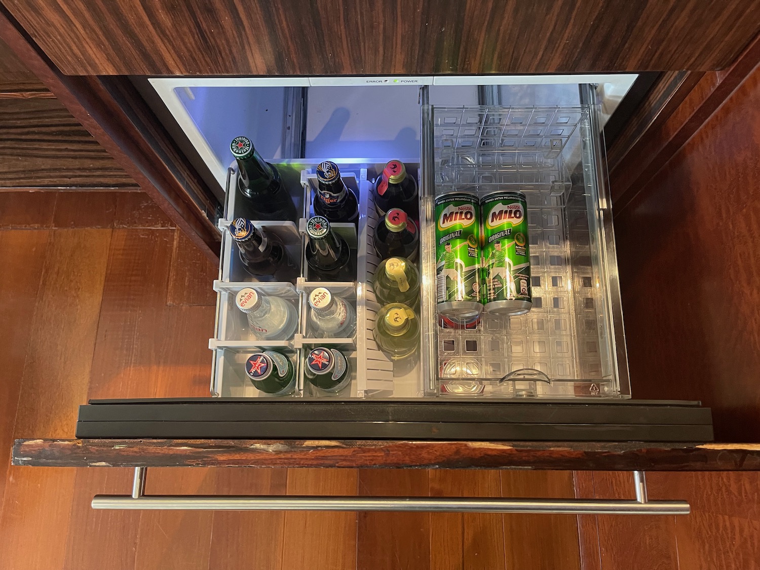 a fridge with bottles of beer and cans inside