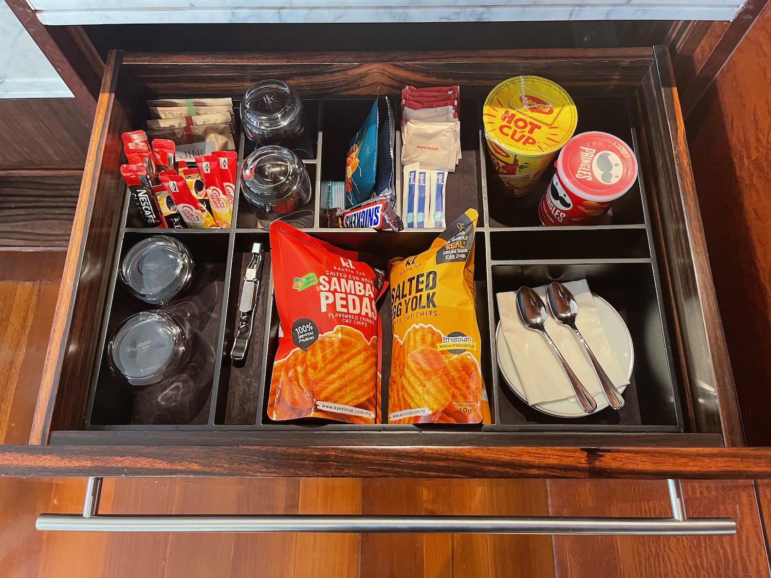 a drawer with food items and utensils