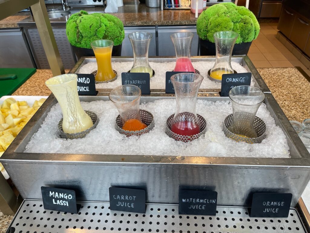 a group of glasses with different drinks in ice