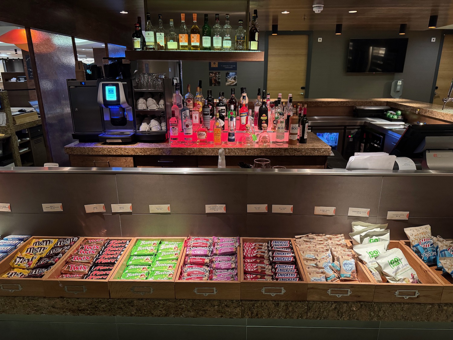 a counter with a variety of liquors and candy