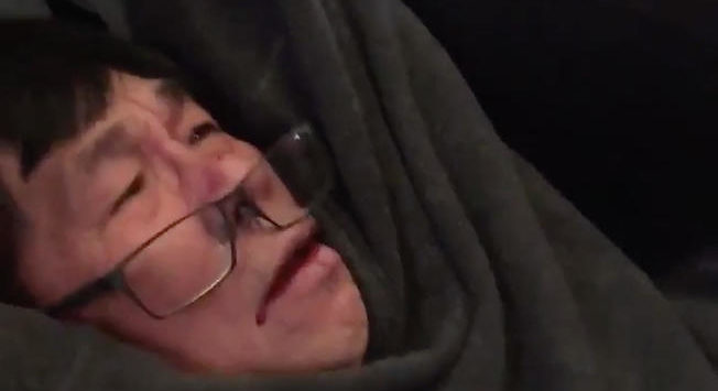 a person with glasses and a blanket