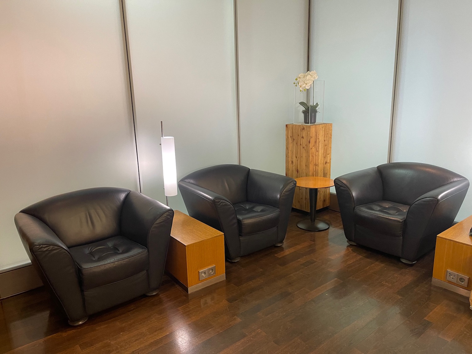 a group of black chairs and a table in a room