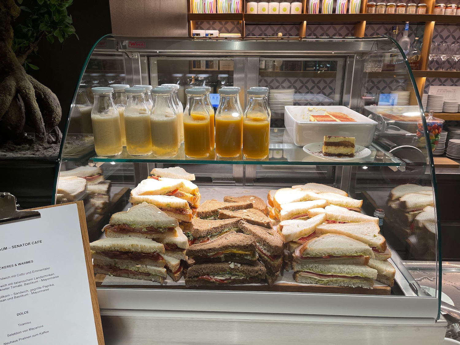 a glass case with sandwiches and drinks