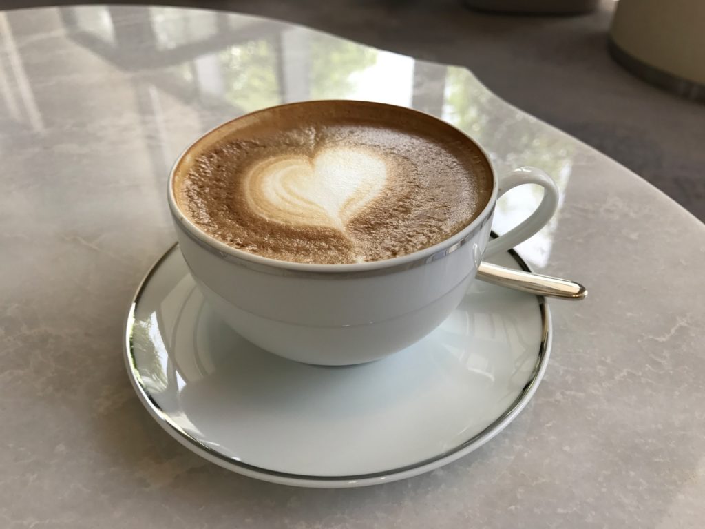 a cup of coffee with a heart in the foam