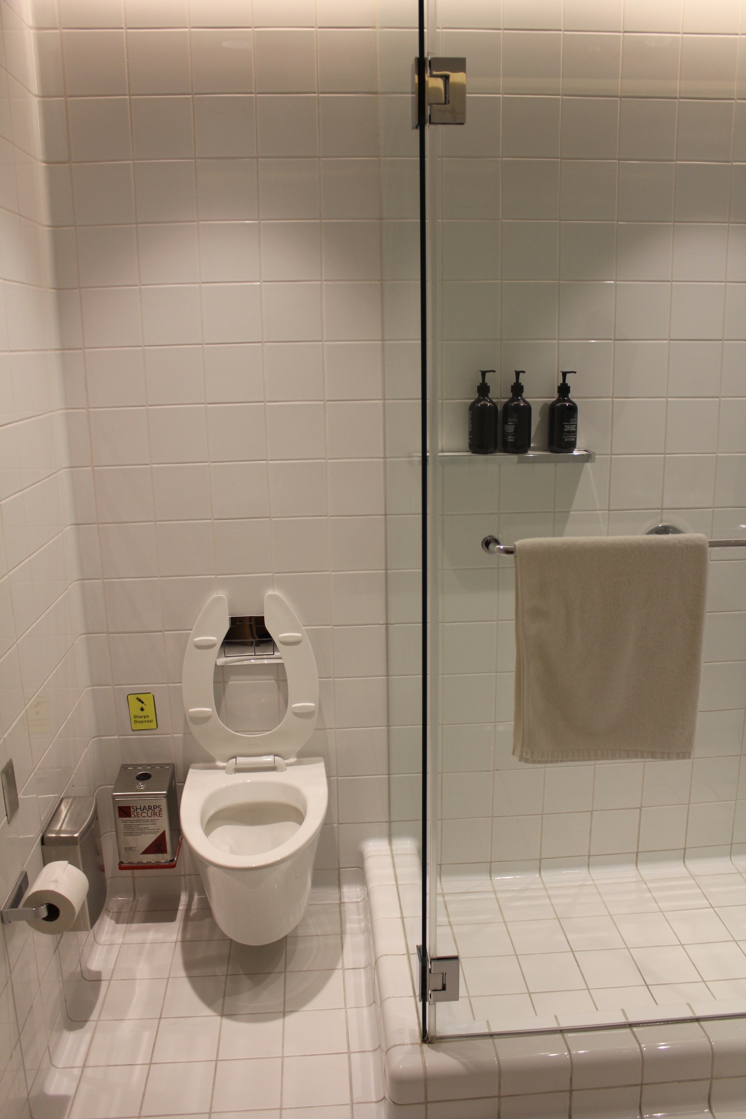 a bathroom with a glass shower door