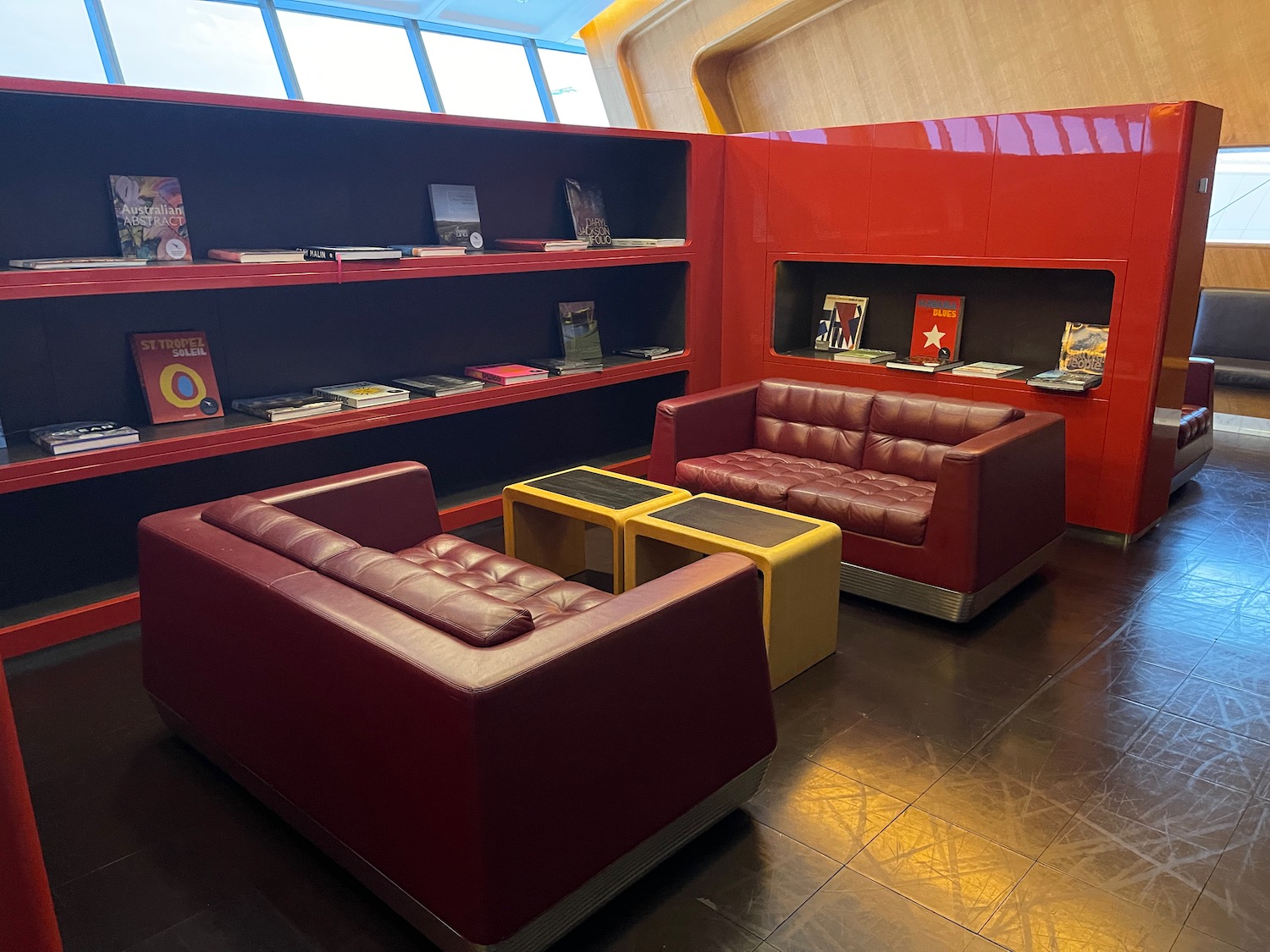 a room with red couches and shelves