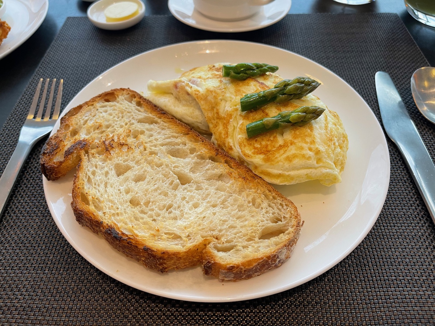 a plate of toast and asparagus on top