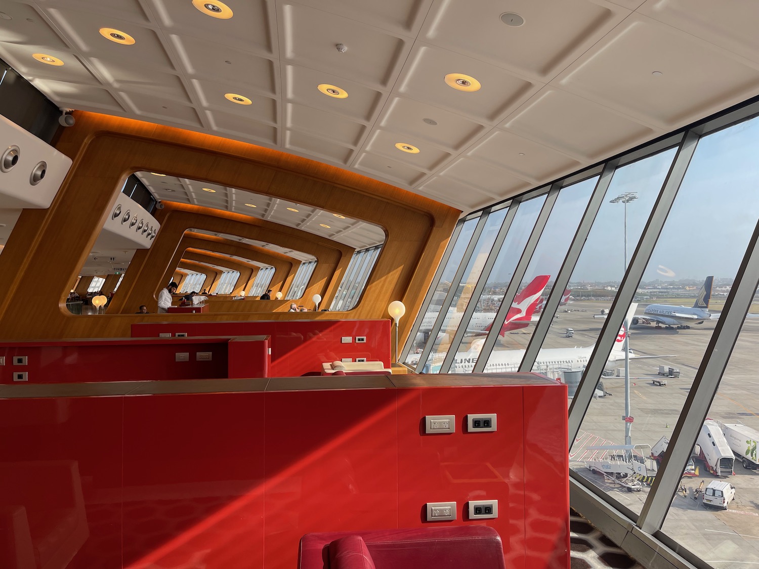 a red counter in a room with windows and a plane in the background