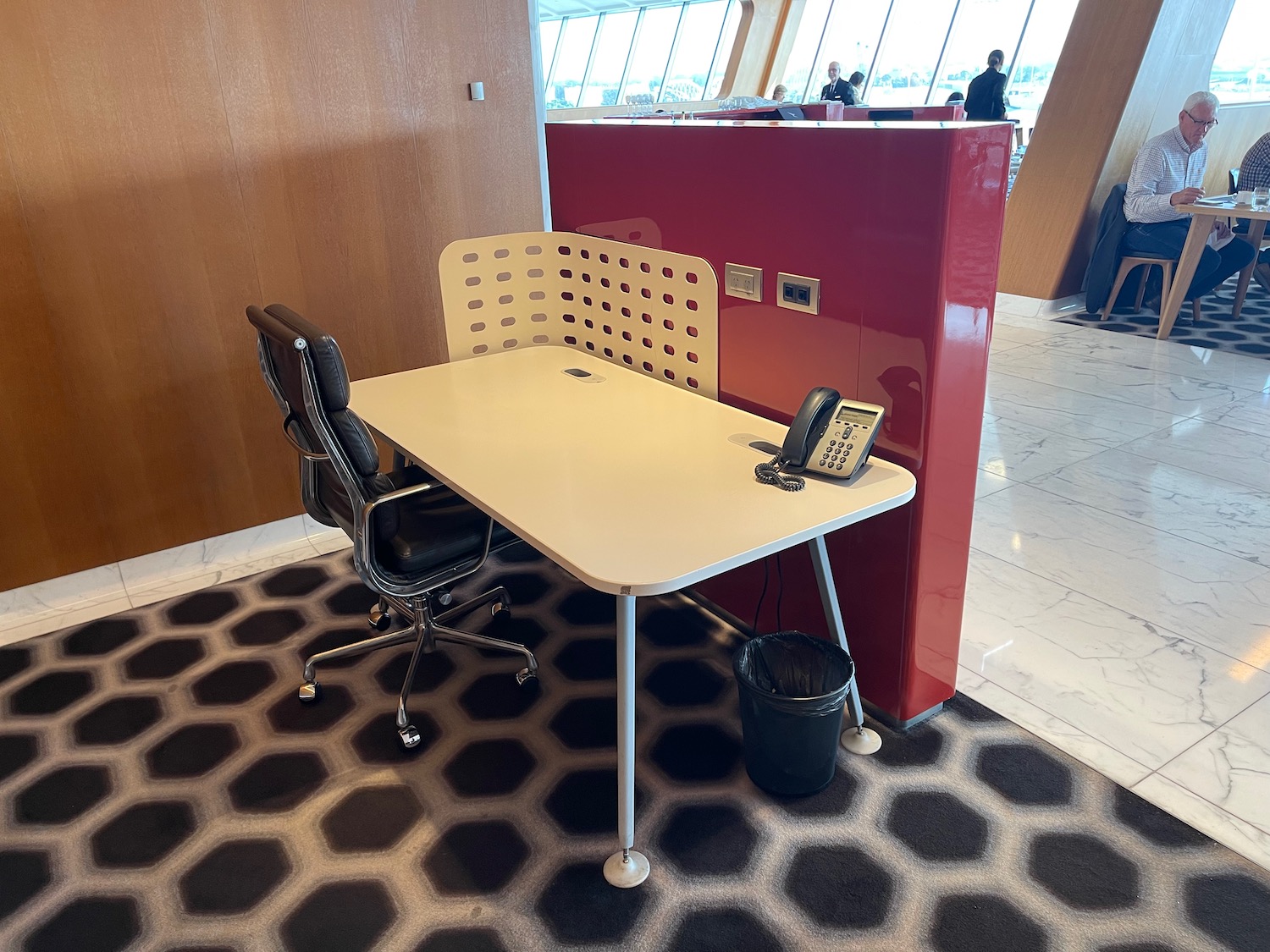 a desk with chairs and a phone on it