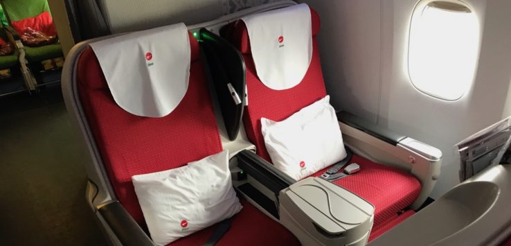 a seat with white pillows on it